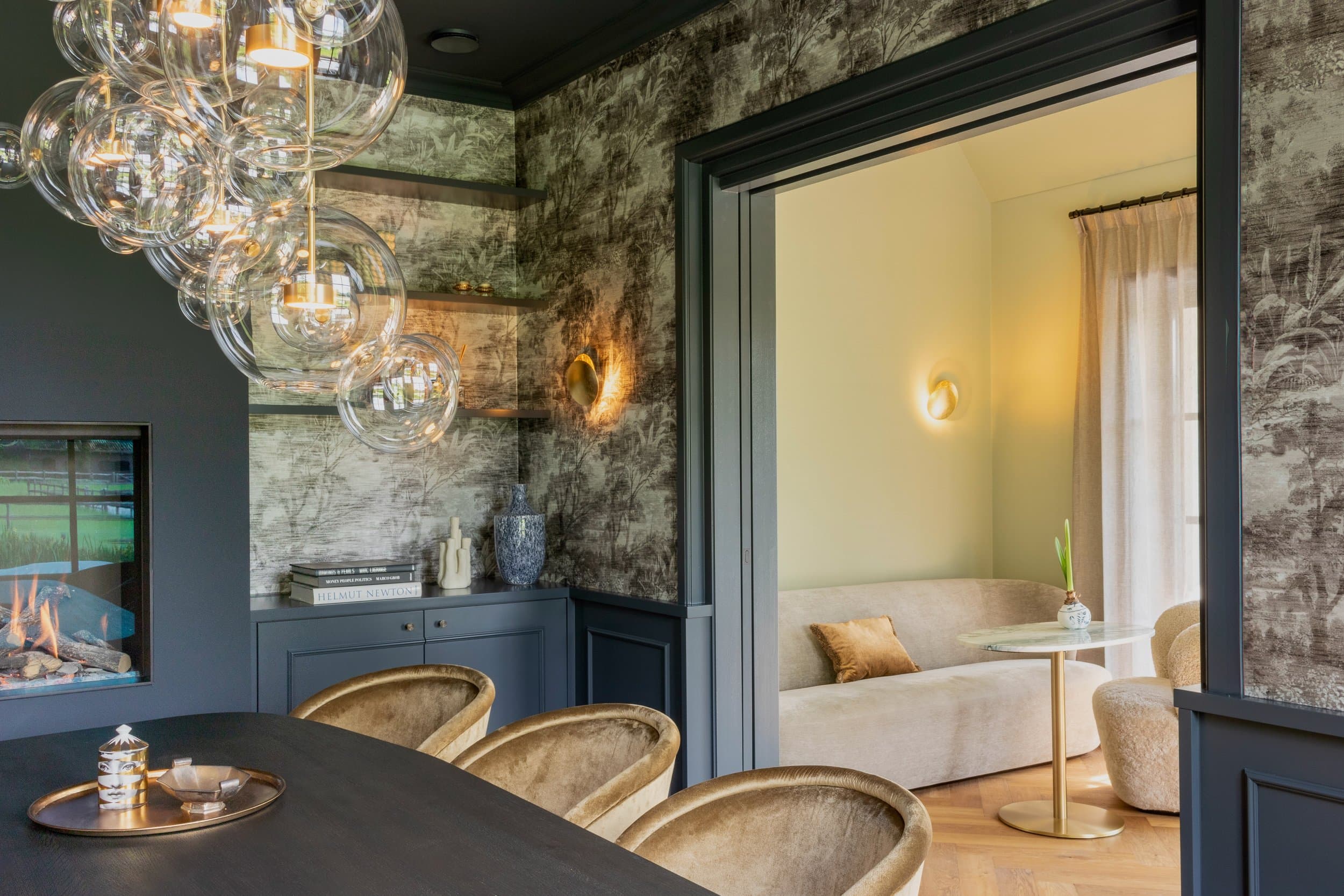 Contemporary living room with dark walls, patterned wallpaper and glass pendants