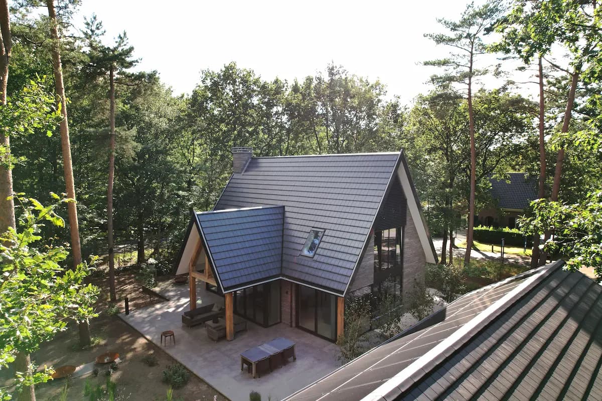 Contemporary home with solar panels and wooden pergola structure