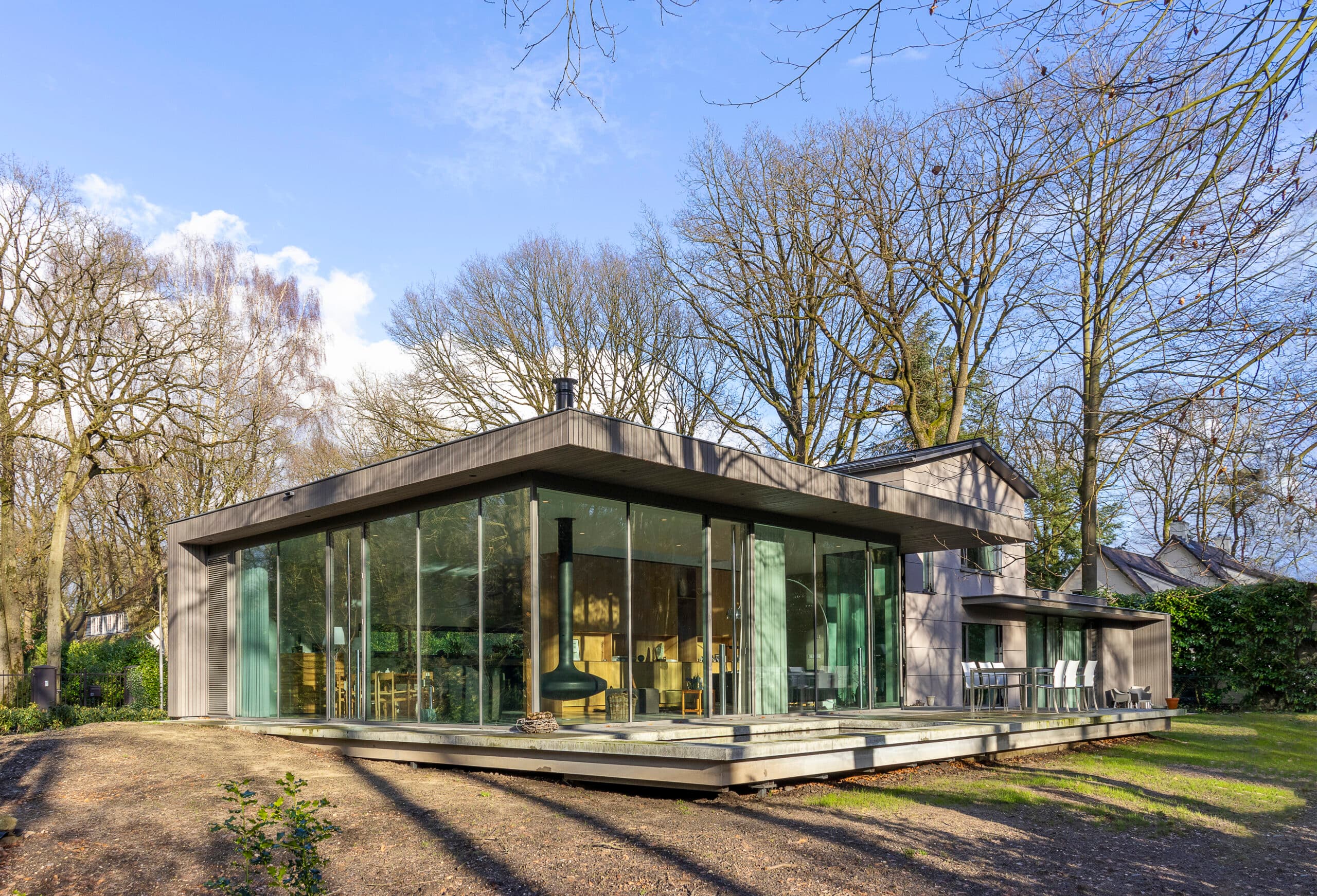 Moderne woonpaviljoen met groot glazen front en betonnen terras
