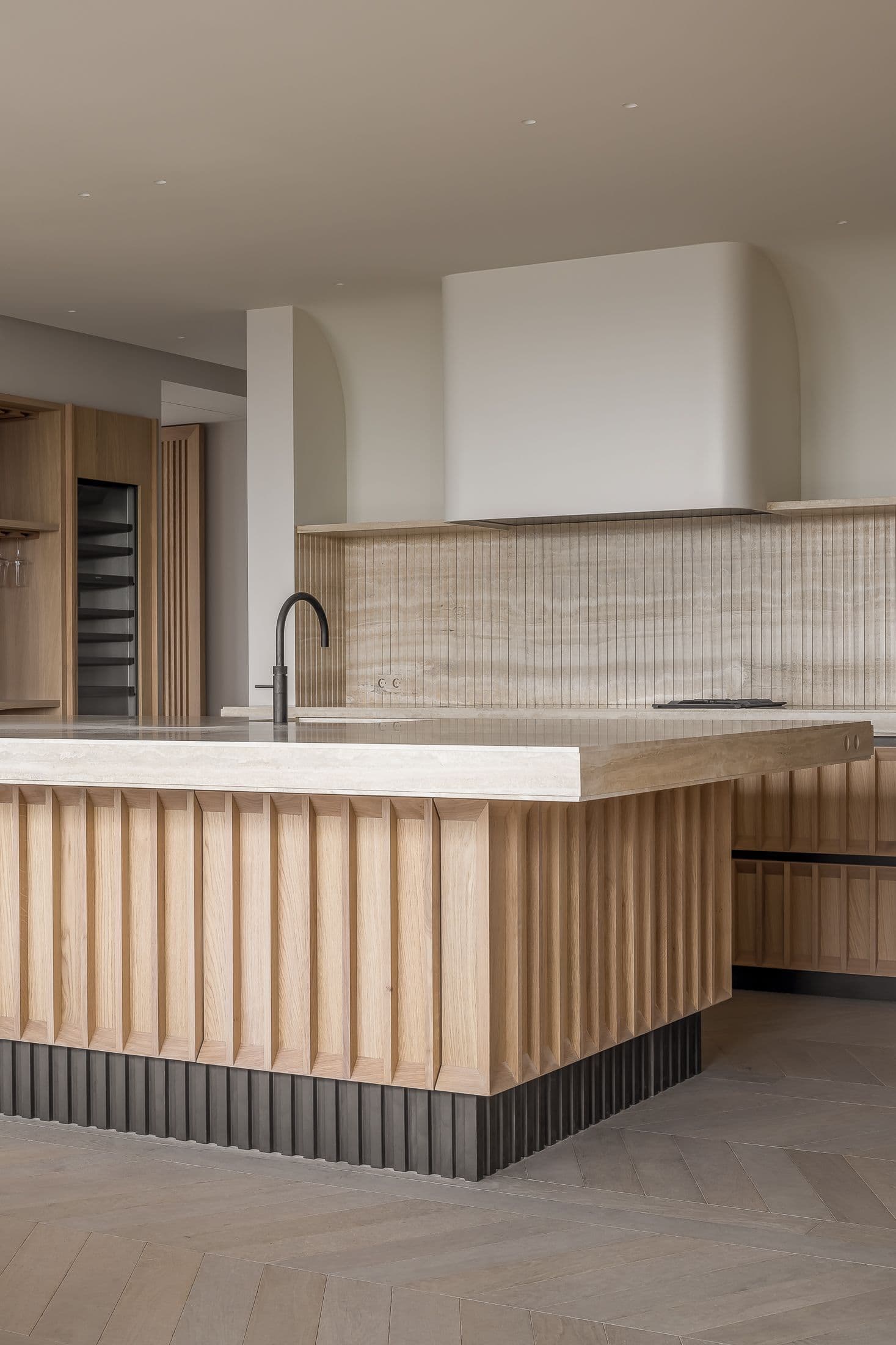 Keuken detail met geribde eikenhouten eiland en tegel backsplash